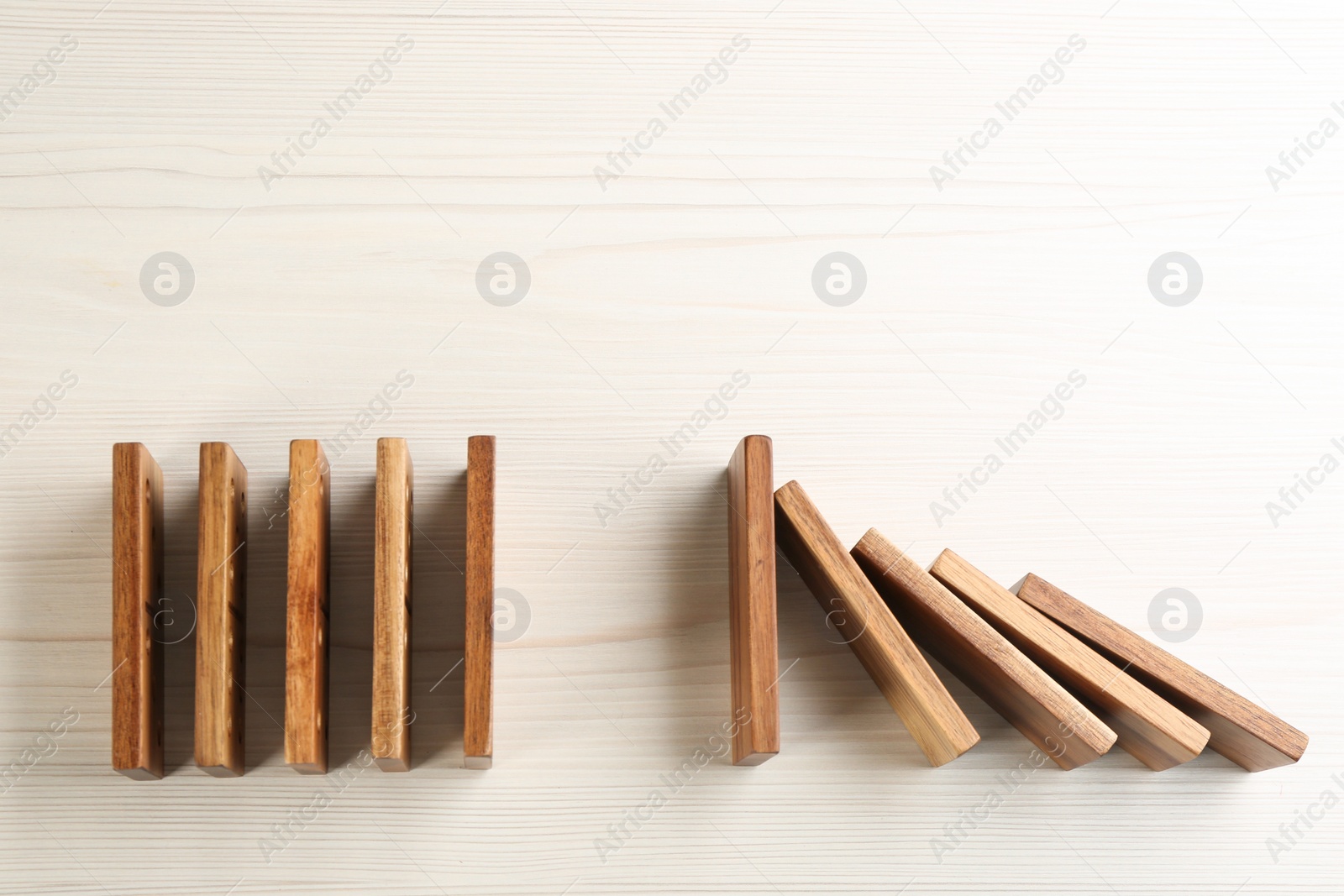 Photo of Wooden domino tiles on white background, flat lay