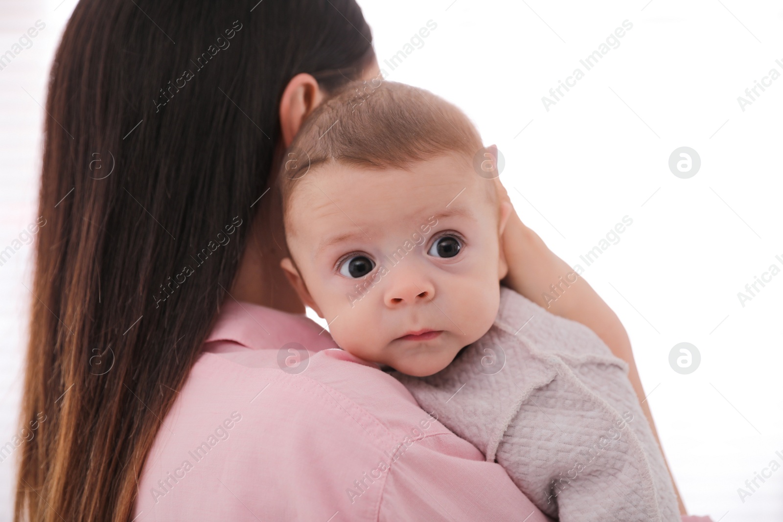 Young woman with her cute baby on white background Photo of Young woman with her cute baby on white background