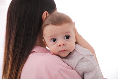 Photo of Young woman with her cute baby on white background
