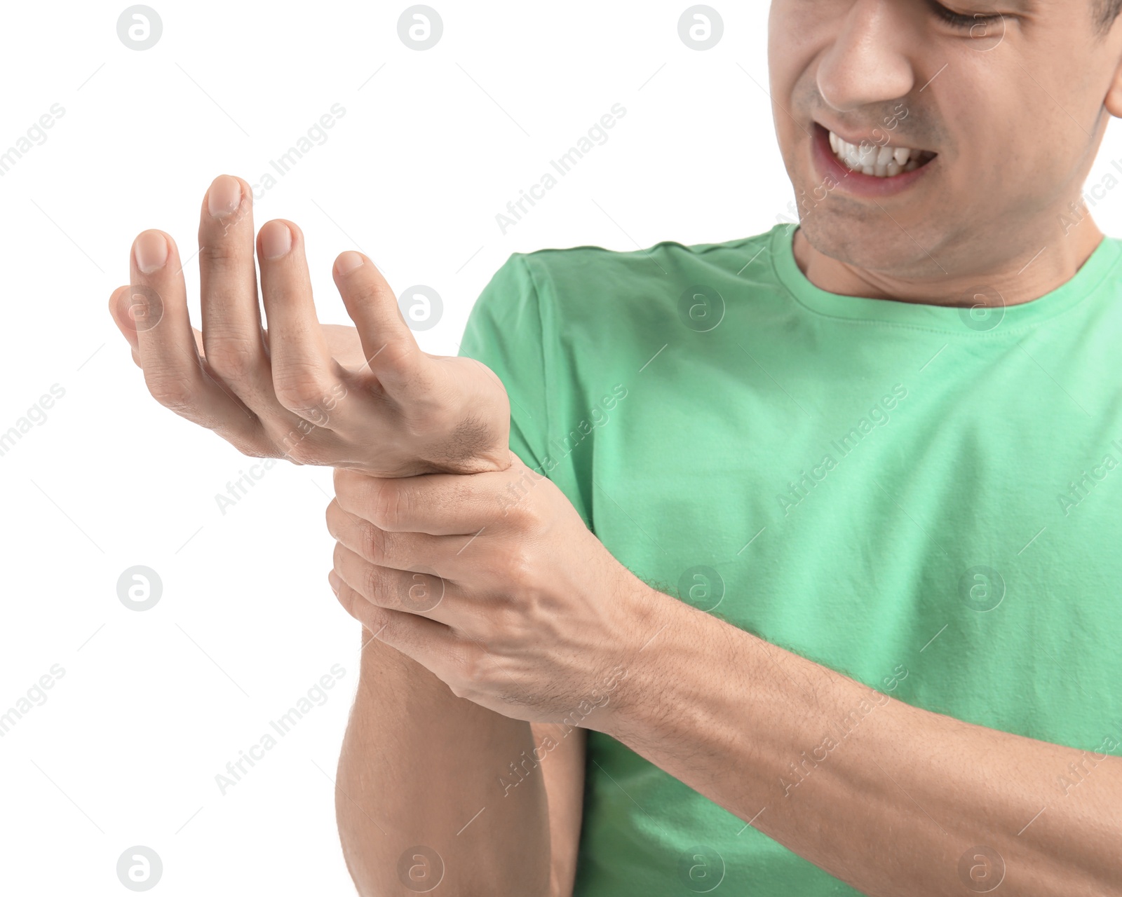 Young man suffering from pain in wrist on white background, closeup Photo of Young man suffering from pain in wrist on white background, closeup