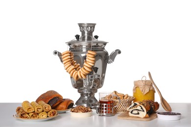 Traditional Russian samovar with treats isolated on white Photo of Traditional Russian samovar with treats isolated on white