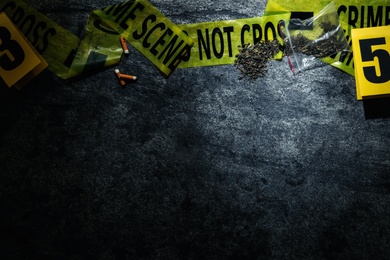 Flat lay composition with evidences and crime scene tape on grey stone background, space for text Photo of Flat lay composition with evidences and crime scene tape on grey stone background, space for text