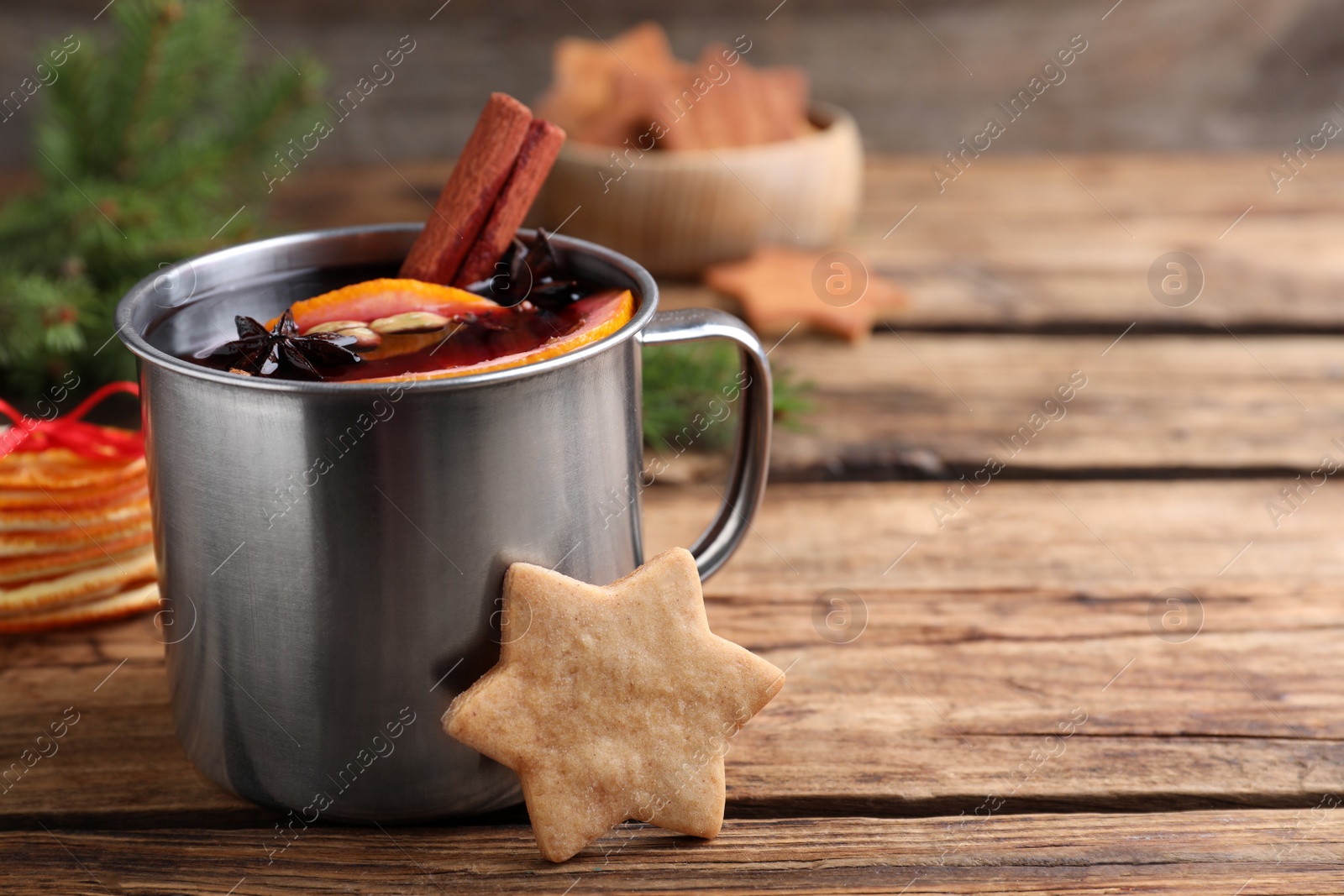 Aromatic mulled wine and cookie on wooden table, closeup. Space for text Photo of Aromatic mulled wine and cookie on wooden table, closeup. Space for text