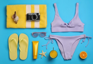 Flat lay composition with beach objects on light blue background Photo of Flat lay composition with beach objects on light blue background
