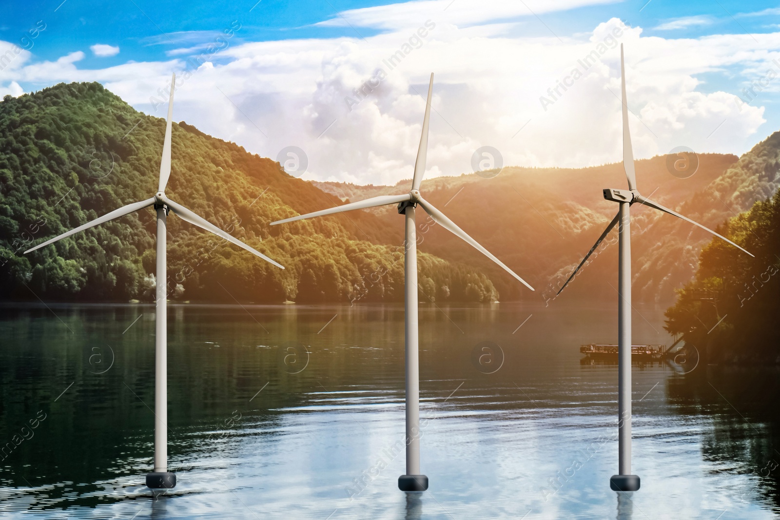 Floating wind turbines installed in water near mountains. Alternative energy source Image of Floating wind turbines installed in water near mountains. Alternative energy source