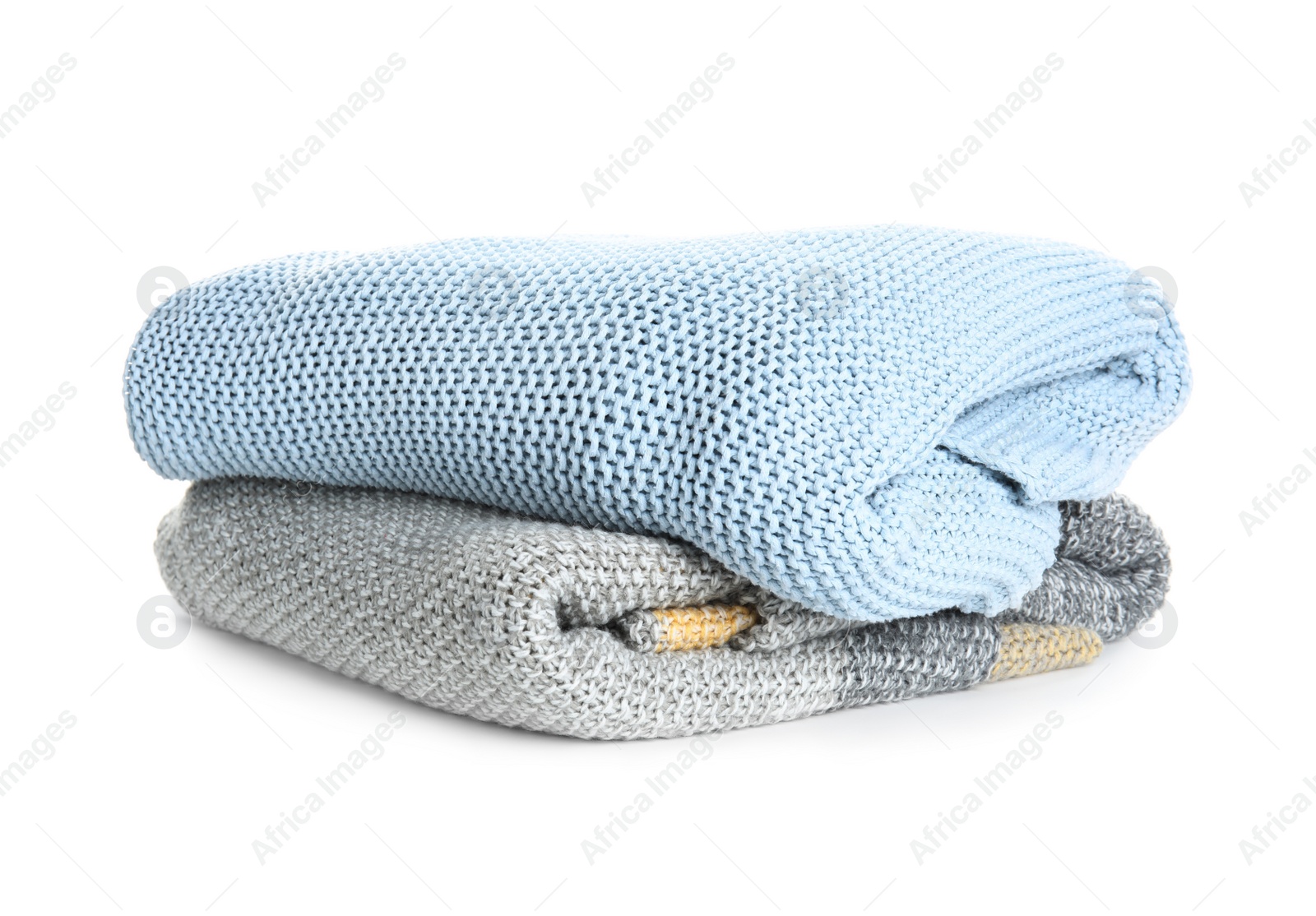 Different stylish knitted plaids on white background Photo of Different stylish knitted plaids on white background