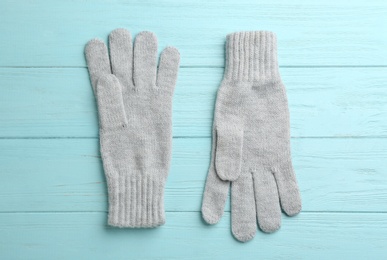 Pair of stylish woolen gloves on light blue wooden background, flat lay Photo of Pair of stylish woolen gloves on light blue wooden background, flat lay