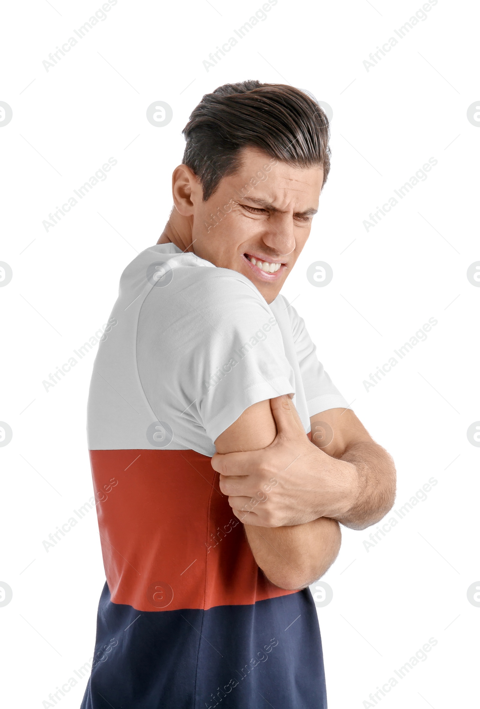 Young man suffering from pain in arm on white background Photo of Young man suffering from pain in arm on white background