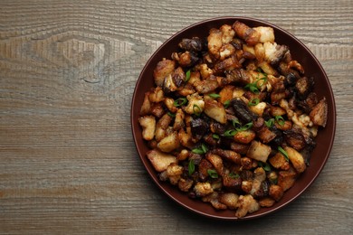 Tasty fried cracklings on wooden table, top view with space for text. Cooked pork lard Photo of Tasty fried cracklings on wooden table, top view with space for text. Cooked pork lard