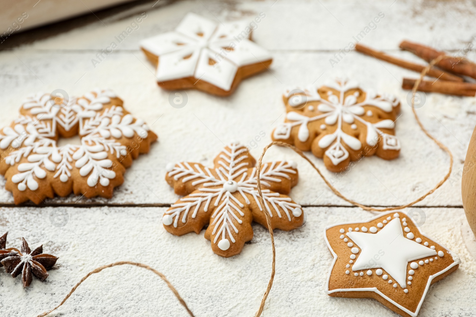 Delicious homemade Christmas cookies and flour on wooden table, closeup Photo of Delicious homemade Christmas cookies and flour on wooden table, closeup