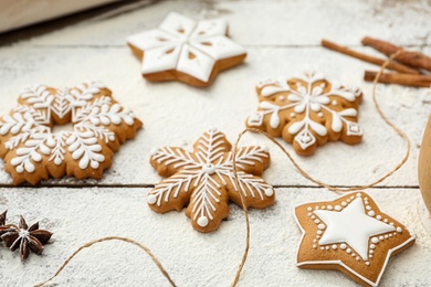 Delicious homemade Christmas cookies and flour on wooden table, closeup Photo of Delicious homemade Christmas cookies and flour on wooden table, closeup