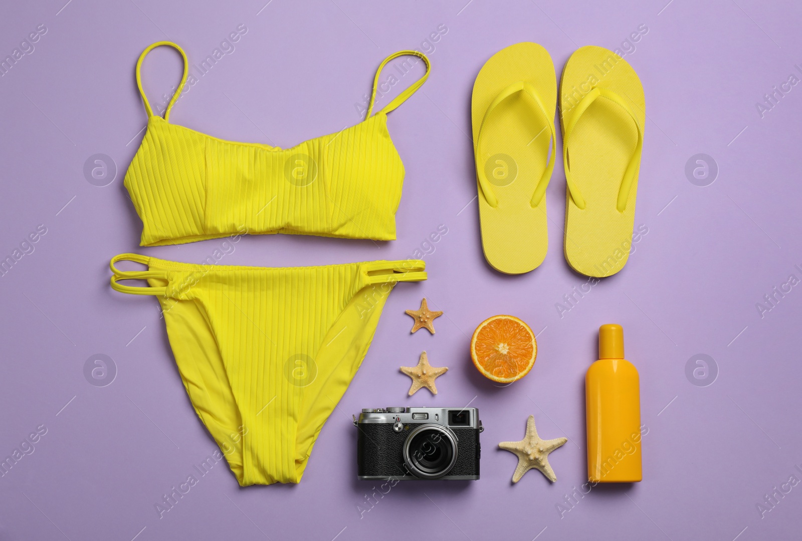 Flat lay composition with beach objects on violet background Photo of Flat lay composition with beach objects on violet background