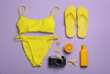 Flat lay composition with beach objects on violet background Photo of Flat lay composition with beach objects on violet background