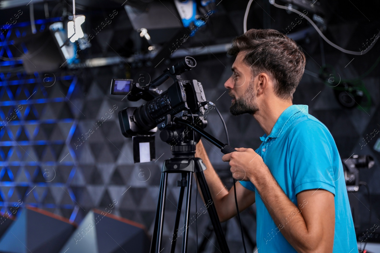 Professional video camera operator working in studio Photo of Professional video camera operator working in studio