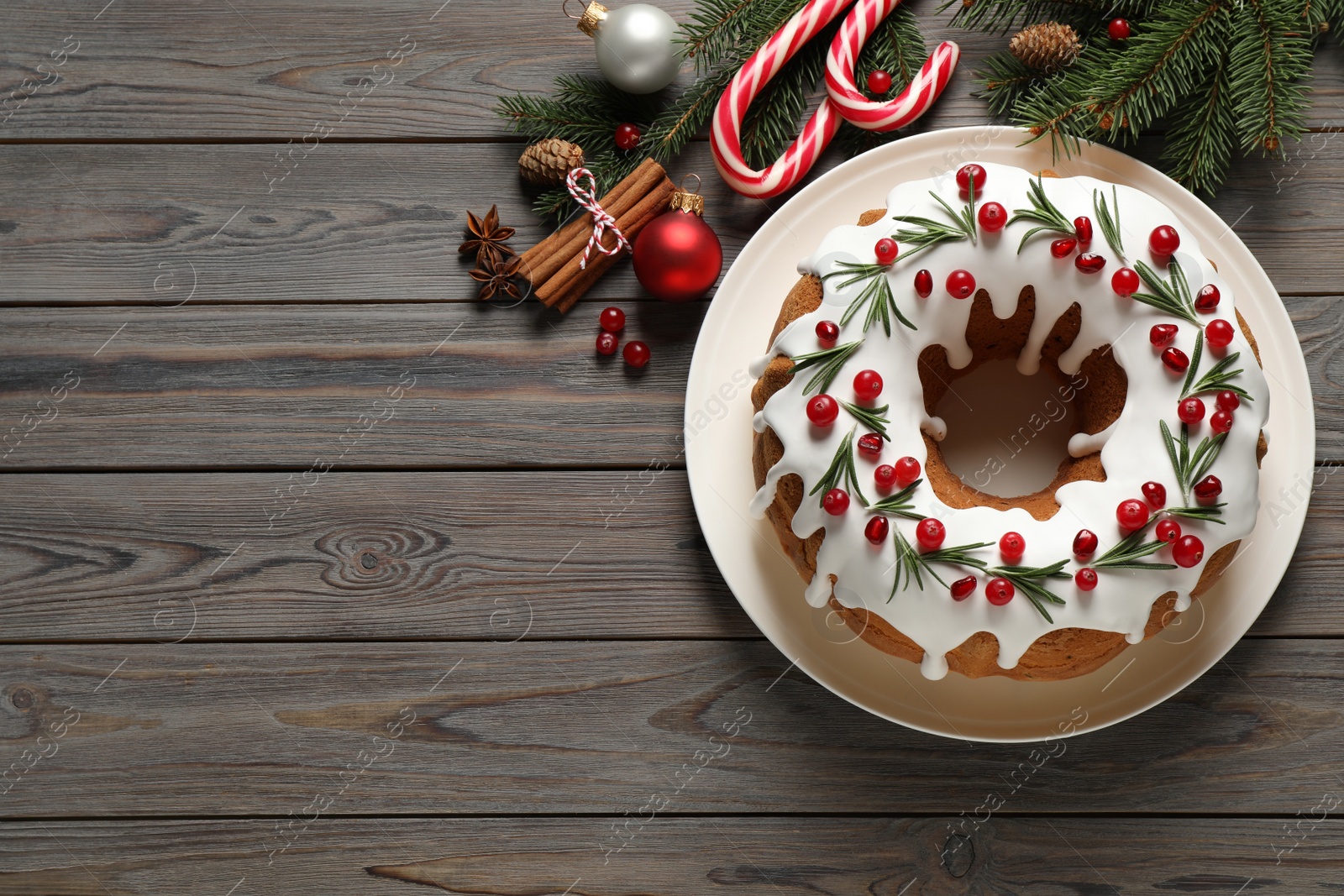 Flat lay composition with traditional Christmas cake and decorations on wooden table, space for text Photo of Flat lay composition with traditional Christmas cake and decorations on wooden table, space for text