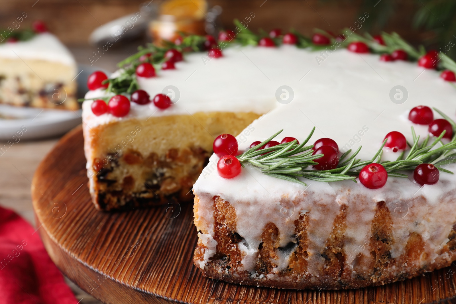Traditional Christmas cake decorated with rosemary and cranberries on tray, closeup Photo of Traditional Christmas cake decorated with rosemary and cranberries on tray, closeup