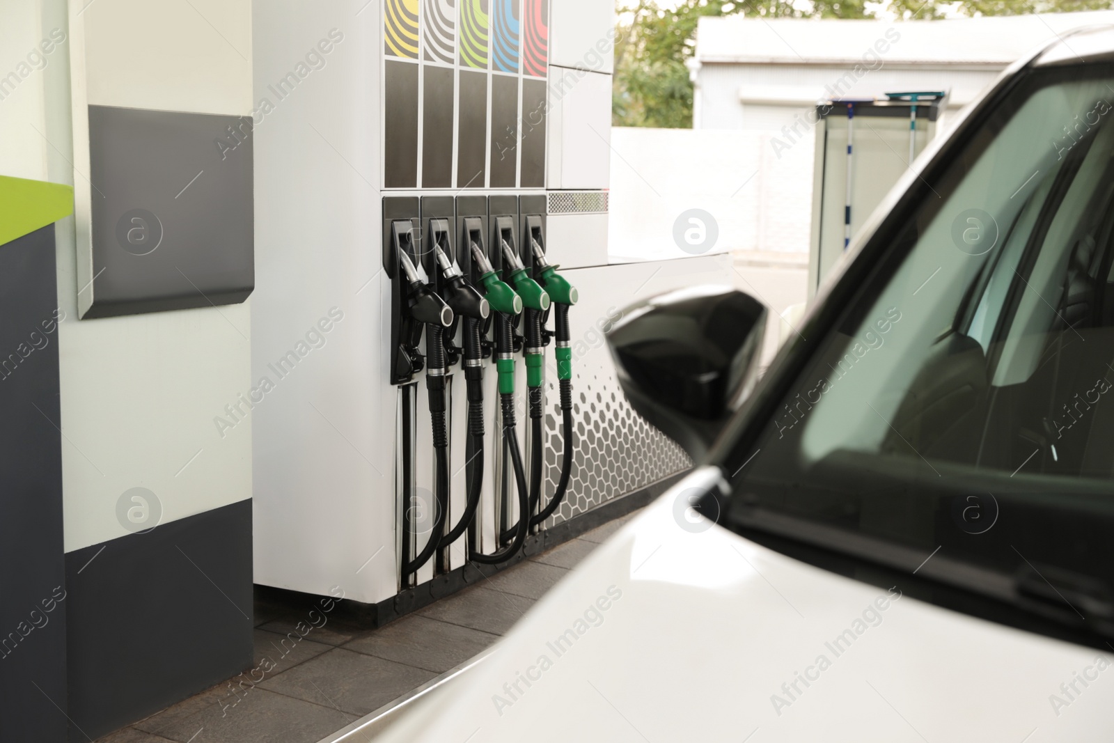 Photo of Refueling modern car at gas filling station, closeup