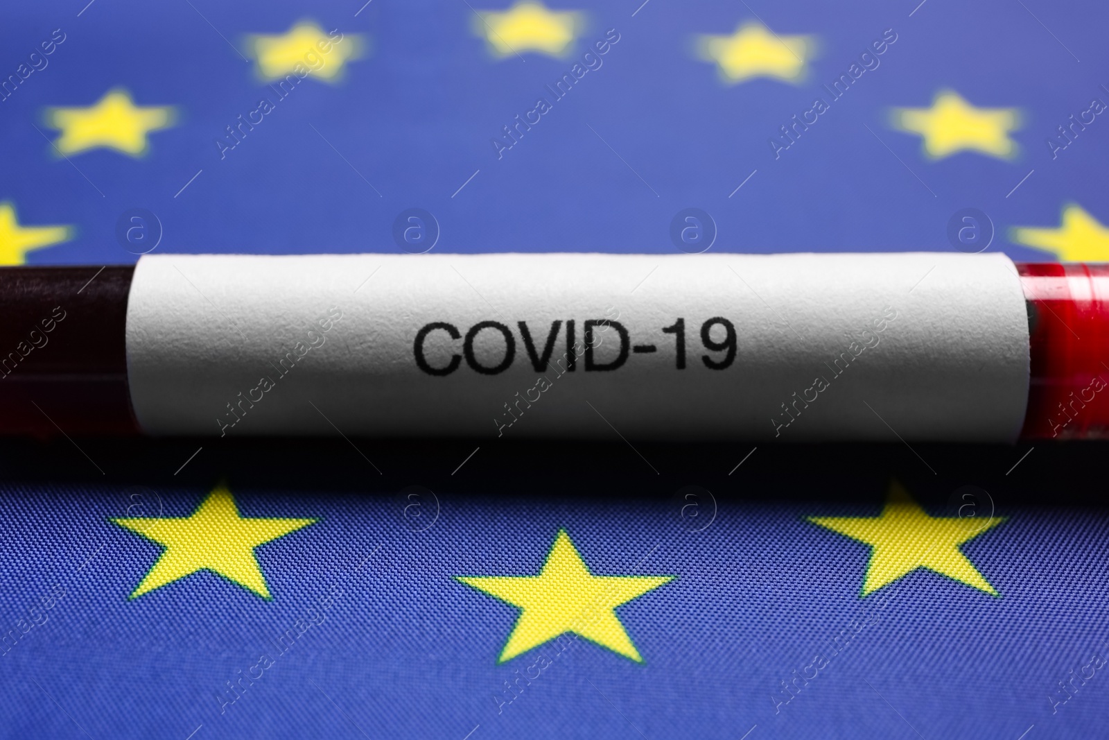 Test tube with blood sample on European Union flag background, closeup. Coronavirus outbreak Photo of Test tube with blood sample on European Union flag background, closeup. Coronavirus outbreak