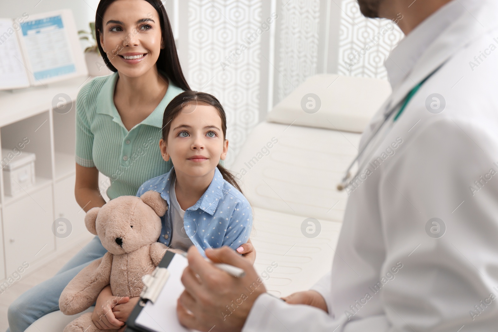 Mother with daughter visiting pediatrician in hospital Photo of Mother with daughter visiting pediatrician in hospital