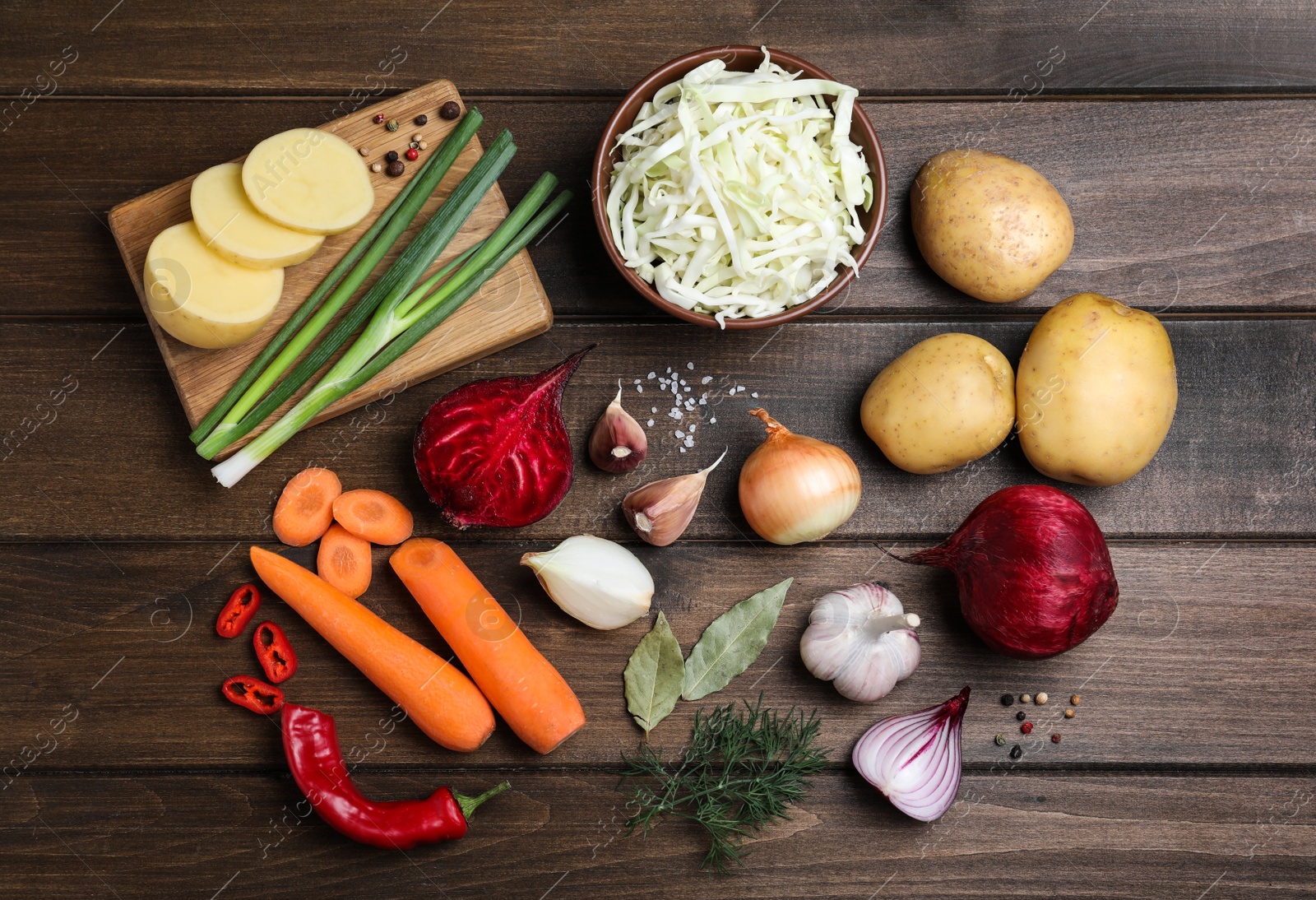Fresh ingredients for borscht on wooden table, flat lay Photo of Fresh ingredients for borscht on wooden table, flat lay