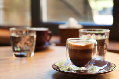 Aromatic coffee on wooden table in cafe. Space for text Photo of Aromatic coffee on wooden table in cafe. Space for text