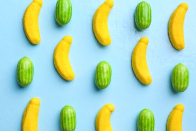 Many delicious candies on light blue background, flat lay Photo of Many delicious candies on light blue background, flat lay
