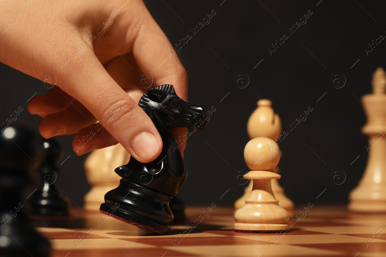 Woman moving chess piece on board, closeup Photo of Woman moving chess piece on board, closeup