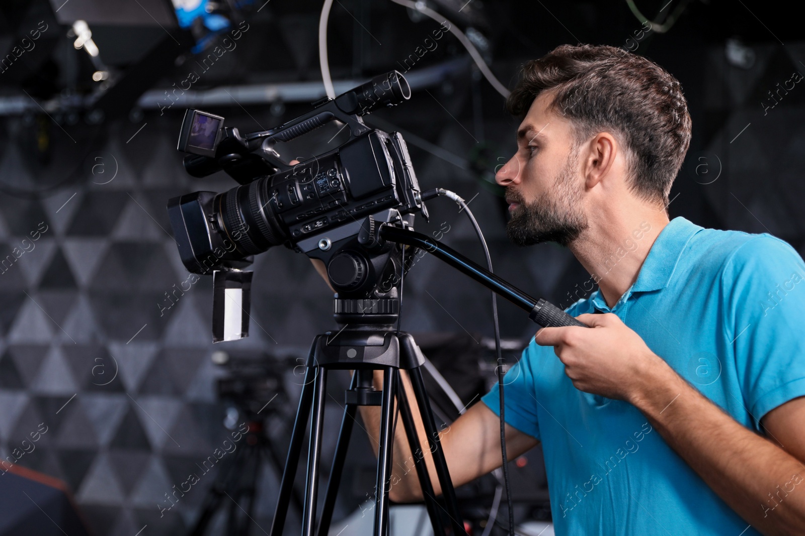 Professional video camera operator working in studio Photo of Professional video camera operator working in studio