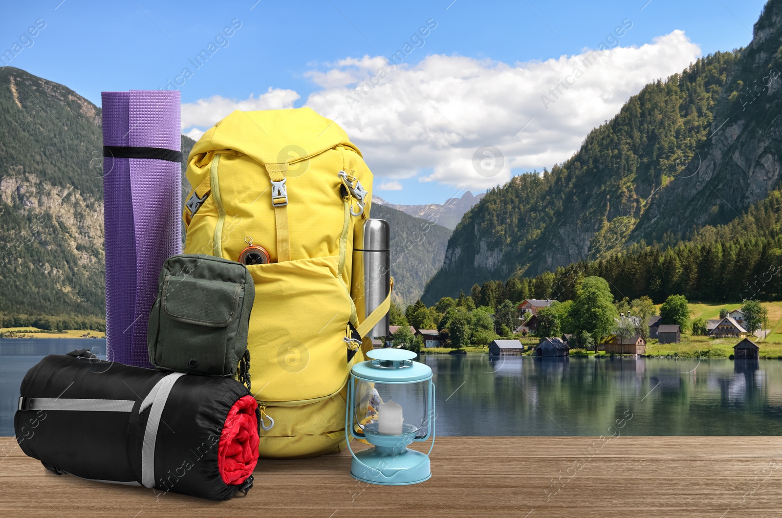 Camping equipment for tourist on wooden surface and beautiful view of mountain landscape Image of Camping equipment for tourist on wooden surface and beautiful view of mountain landscape