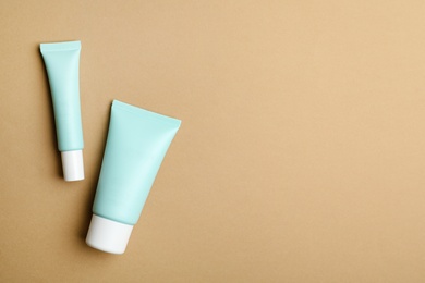 Set of luxury cosmetic products on light brown background, flat lay. Space for text Photo of Set of luxury cosmetic products on light brown background, flat lay. Space for text