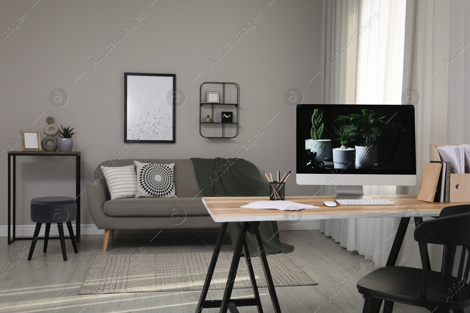 Comfortable workplace with computer on wooden desk in modern office. Interior design Photo of Comfortable workplace with computer on wooden desk in modern office. Interior design