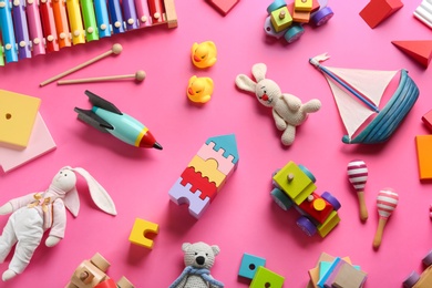 Flat lay composition with different toys on pink background Photo of Flat lay composition with different toys on pink background