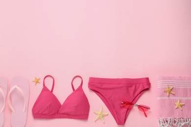 Stylish bikini and beach accessories on pink background, flat lay. Space for text Photo of Stylish bikini and beach accessories on pink background, flat lay. Space for text
