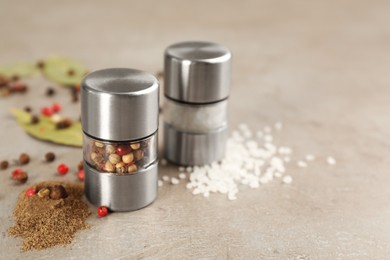 Salt and pepper shakers on light grey table, closeup. Space for text Photo of Salt and pepper shakers on light grey table, closeup. Space for text