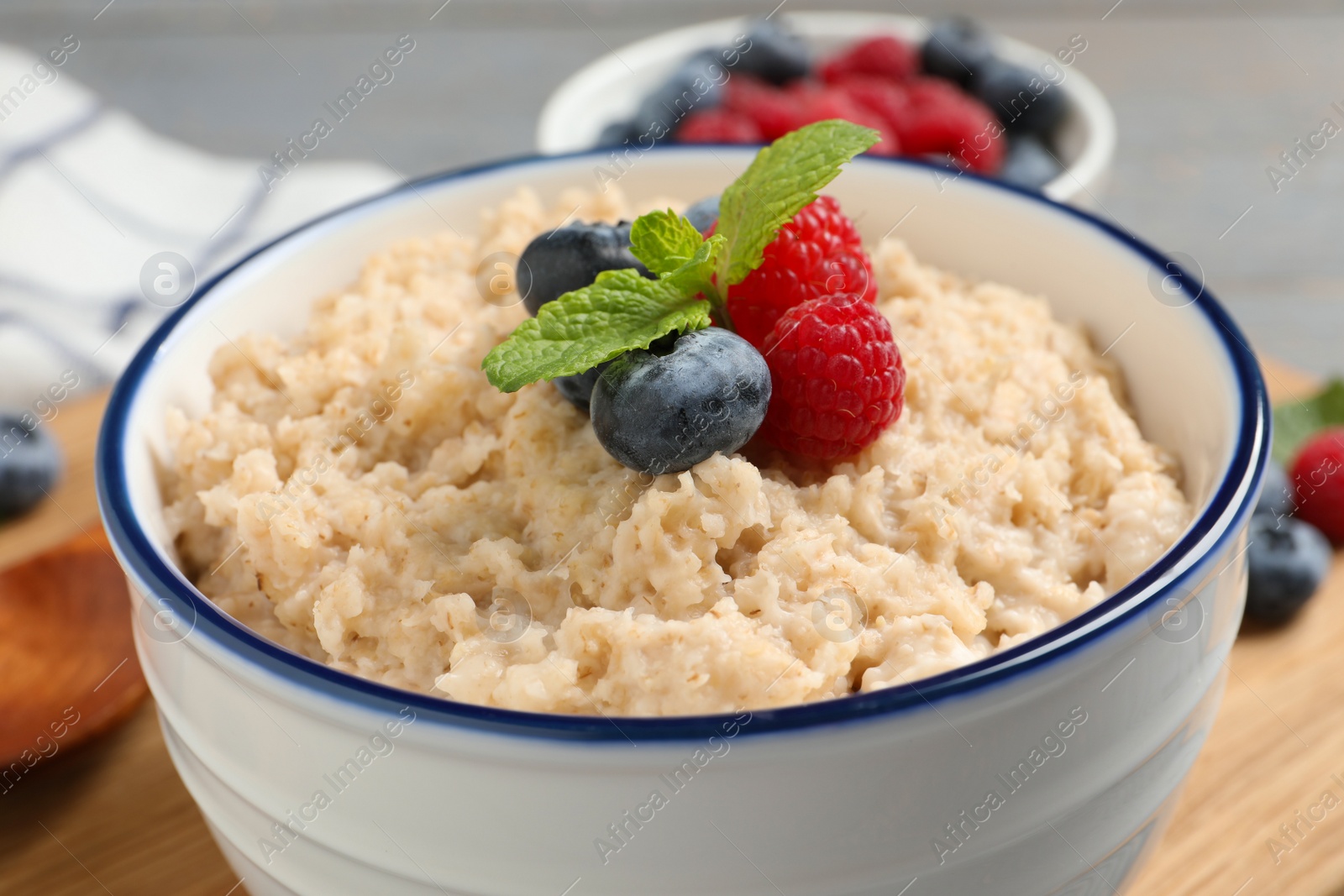 Tasty oatmeal porridge with berries in bowl, closeup Photo of Tasty oatmeal porridge with berries in bowl, closeup