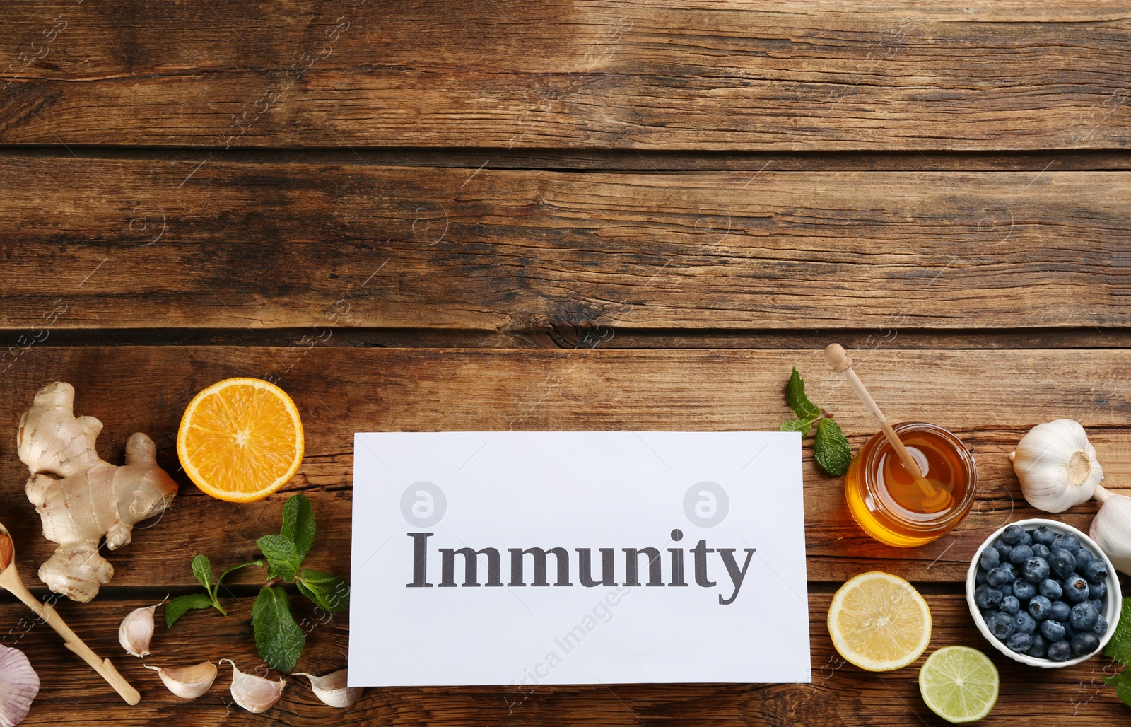 Card with phrase Immunity and fresh products on wooden table, flat lay. Space for text Photo of Card with phrase Immunity and fresh products on wooden table, flat lay. Space for text