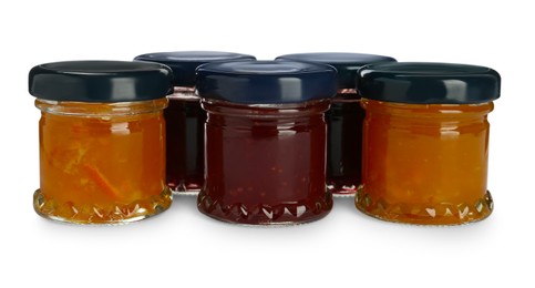 Jars with different jams on white background Photo of Jars with different jams on white background