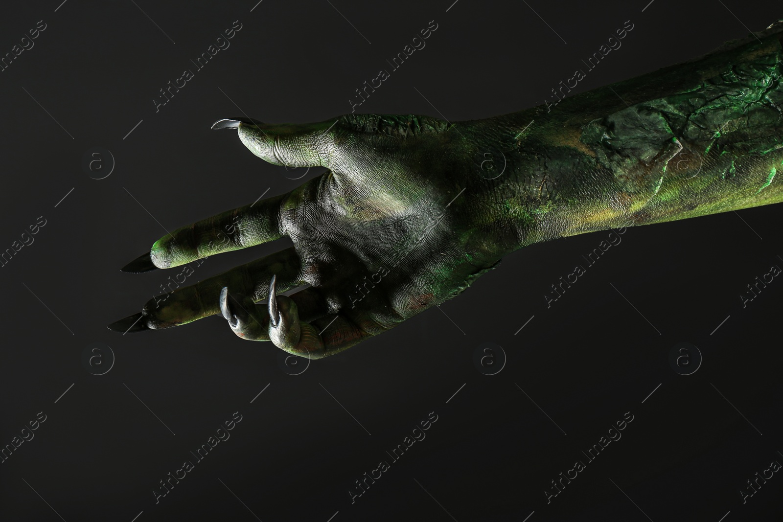 Scary monster on black background, closeup of hand. Halloween character Photo of Scary monster on black background, closeup of hand. Halloween character