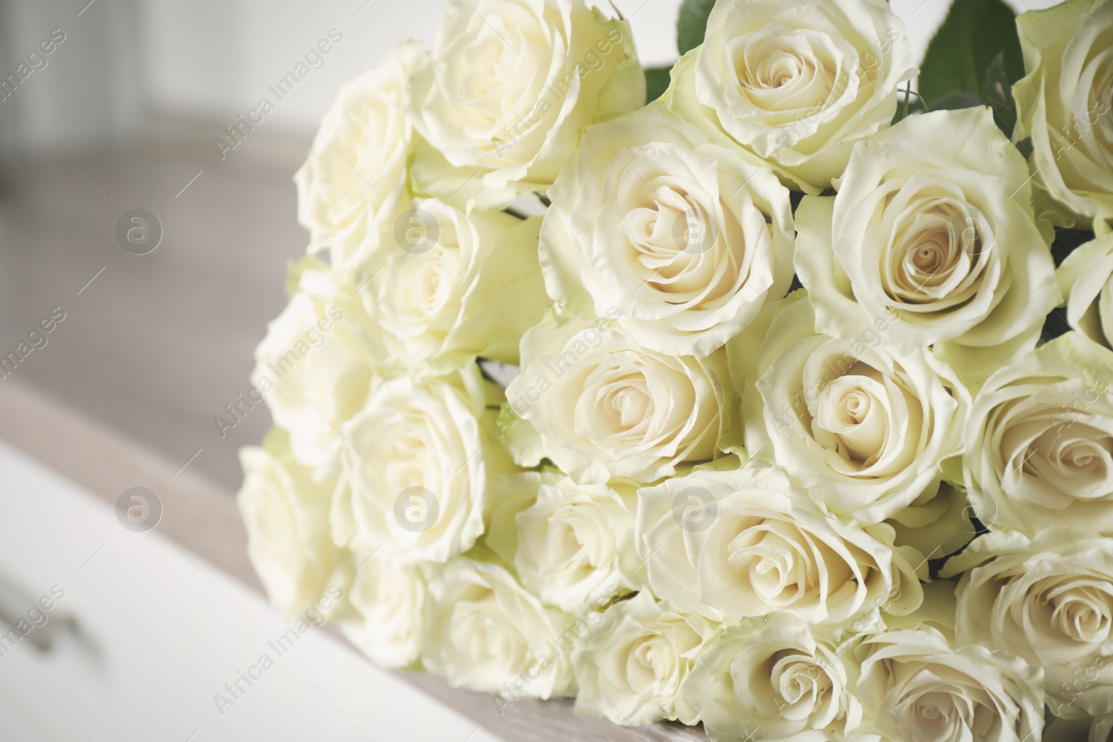 Luxury bouquet of fresh roses on commode, closeup Photo of Luxury bouquet of fresh roses on commode, closeup