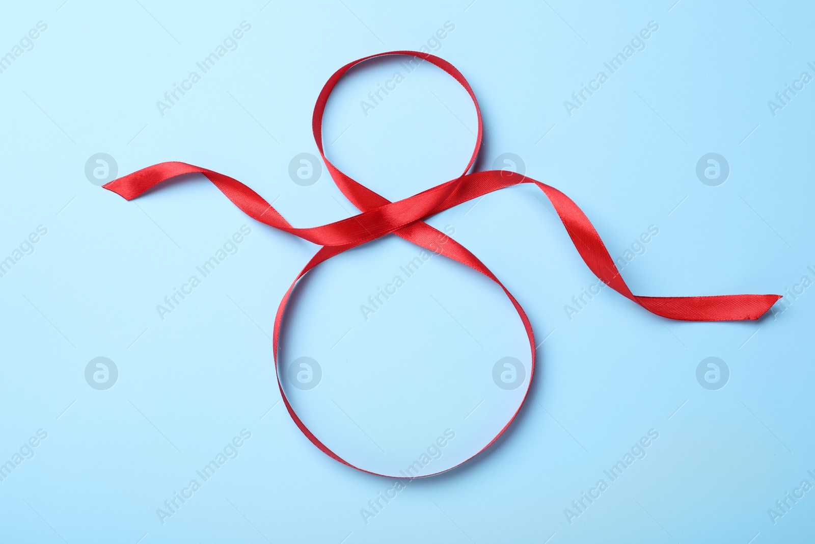 Number 8 of red ribbon on light blue background, top view. International Women's day Photo of Number 8 of red ribbon on light blue background, top view. International Women's day