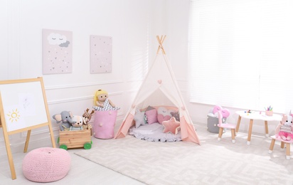 Cute child's room interior with toys, modern furniture and play tent Photo of Cute child's room interior with toys, modern furniture and play tent