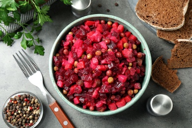 Photo of Traditional Russian salad vinaigrette served on grey table, flat lay