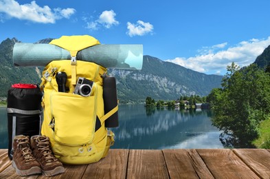 Camping equipment for tourist on wooden surface and beautiful view of mountain landscape Image of Camping equipment for tourist on wooden surface and beautiful view of mountain landscape