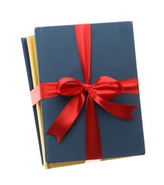 Different books tied with red ribbon isolated on white Photo of Different books tied with red ribbon isolated on white
