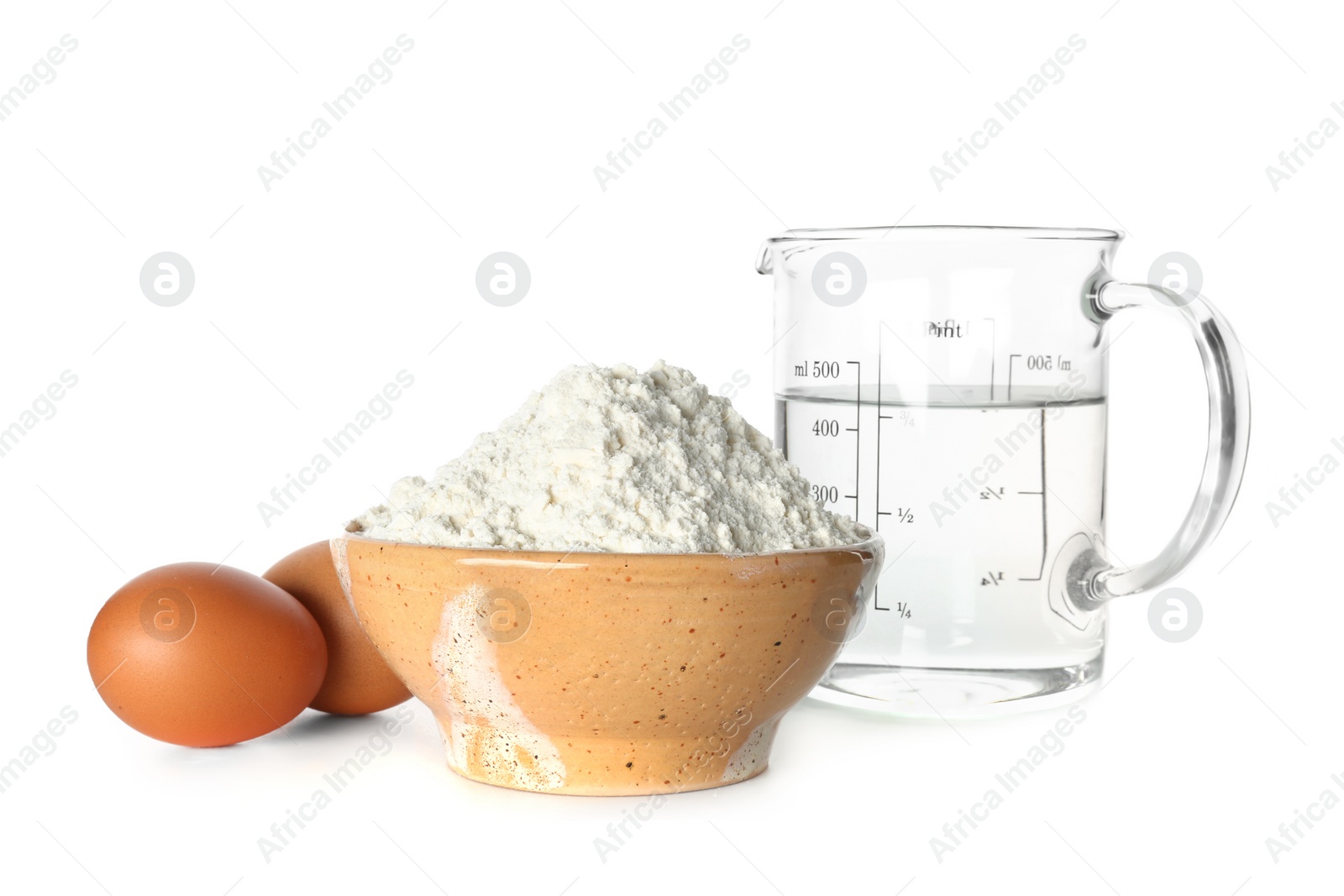 Wheat flour, eggs and jug of water on white background Photo of Wheat flour, eggs and jug of water on white background