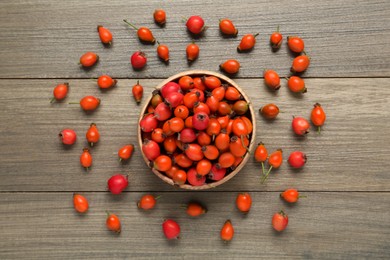 Ripe rose hip berries on wooden table, flat lay Photo of Ripe rose hip berries on wooden table, flat lay