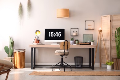 Room interior with comfortable workplace. Modern computer on wooden desk Photo of Room interior with comfortable workplace. Modern computer on wooden desk