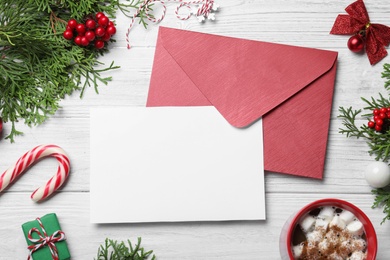 Flat lay composition with Christmas decor and blank card on white wooden background. Space for text Photo of Flat lay composition with Christmas decor and blank card on white wooden background. Space for text