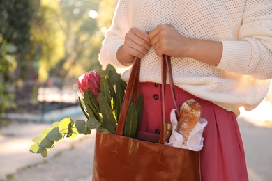 Woman with leather shopper bag outdoors, closeup Photo of Woman with leather shopper bag outdoors, closeup