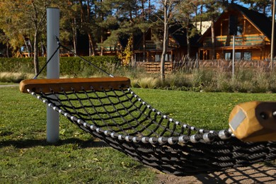 Comfortable net hammock outdoors on sunny day Photo of Comfortable net hammock outdoors on sunny day